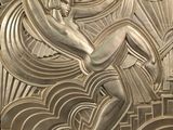 a large metal sculpture of a woman on a surfboard