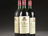 three bottles of red wine sitting on top of a table