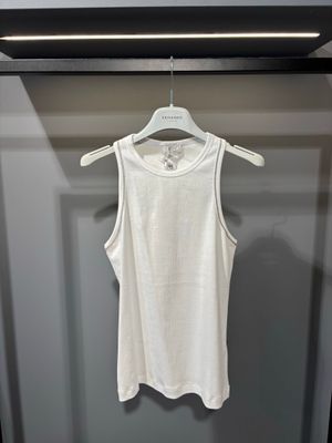 un débardeur blanc suspendu à un cintre dans une armoire
