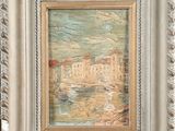 an image of a picture of a painting in a frame on a table