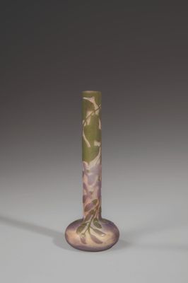 a small vase with a green and white design on it