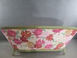 pink and green floraled sofa with green legs