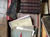 a box full of old books on the floor