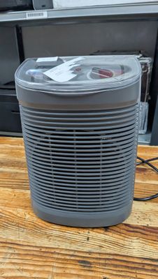a small air purifier sitting on a wooden table