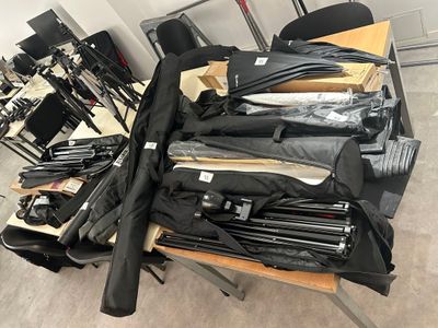 many umbrellas that are on a table in a room