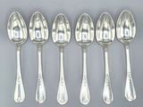 six silver spoons are lined up in a row on a gray surface