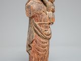 an old wooden statue of a woman holding a child