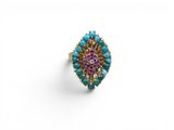 a turquoise, pink and gold ring on a white background