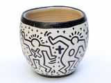 a black and white vase with a design on it