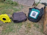 two bags and a backpack sitting on the ground