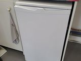 a white dishwasher sitting in a kitchen next to a sink