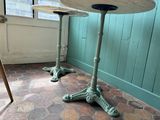 two tables that are sitting on the floor in the room