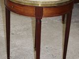 a small table with a marble top on the floor