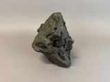 a close up of a sculpture of a rock on a white surface