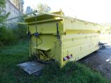 a yellow dump truck that is parked in the grass