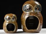 three ceramic owls sitting next to each other on a table