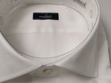 white dress shirt with a black label on the collar and cuffs