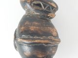 an image of a wooden sculpture of a rabbit on a pedestal