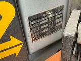 a close up of a machine with a yellow arrow on it