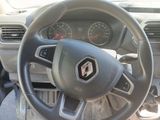 the steering wheel and dashboard of a car with a clock on it