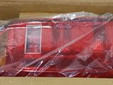 a box with a red object in it that is wrapped in plastic