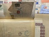 a open book with stamps on it sitting on top of a table