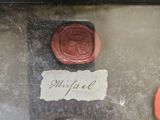 a close up of a piece of paper with wax stamps on it