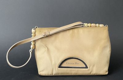 an image of a beige purse with a strap on it