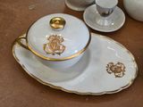 a white and gold tea set on a table