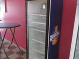 a refrigerator that is sitting in the corner of a room