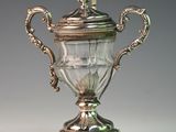 a silver cup that is sitting on top of a table