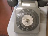 a telephone that is sitting on a table next to a box