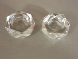 pair of clear glass ashtrays on a table top