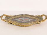 an image of a decorative tray with handles on a white surface