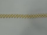 a close up of a bracelet on a white surface
