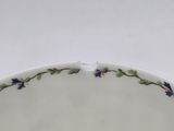 a close up of a white plate with blue flowers on it