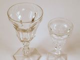 two wine glasses sitting next to each other on a table