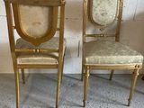 pair of gold painted chairs with upholstered back and upholstered seat