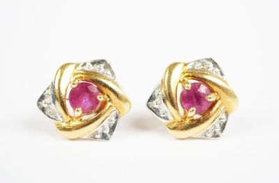 a pair of ruby and diamond earrings