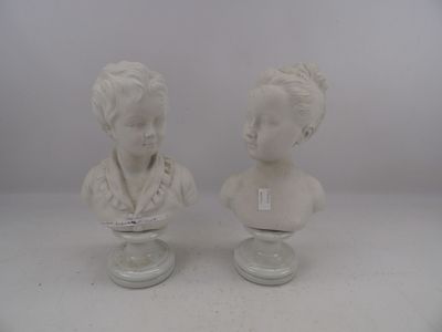 pair of white marble busts of a boy and a girl