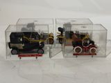 two toy cars in a clear box on a white surface