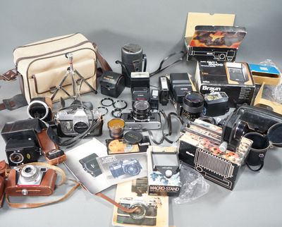 a lot of old cameras and other items on the table
