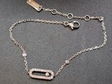 a close up of a silver chain with a diamond pendant on it