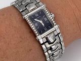 wrist shot of a lady ' s wrist with a watch on it