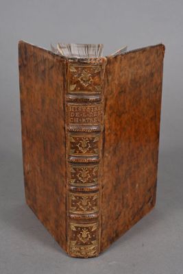 an old leather book with gold trimming on the front and sides
