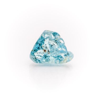 a close up of a blue diamond on a white surface