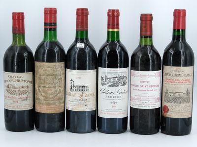 six bottles of wine are lined up in a row on a white surface