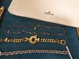 a lot of bracelets and a purse on a table