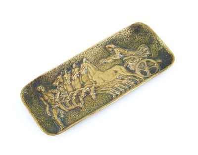 brass plate with a horse and rider on it on a white background