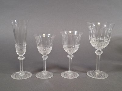 three clear wine glasses sitting on top of a table next to each other